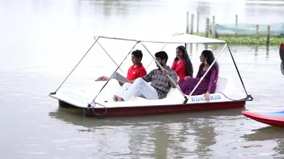 a group of people riding on a boat in the water at Atharvam Resort in Cherai Beach