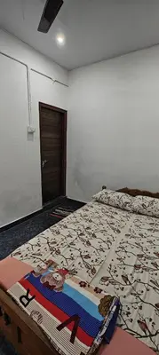 a bedroom with a bed with a comforter on it at Hayden in Kakkadampoyil