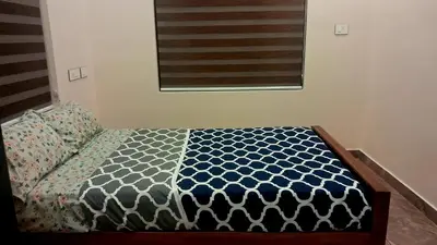 a bed in a bedroom with an american flag at Mendez Residency in Ernakulam
