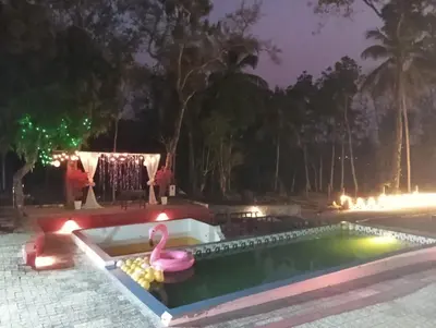 a swimming pool with a pink swan in the middle at The Multi Gen Retreat at gaya3farms in Parli
