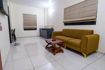a living room with a couch and a coffee table at Hotel Aeronest Residency in Calicut