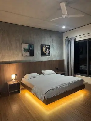 a bedroom with a large bed and a window at A private room in a luxury villa- The Water's Edge in Kotagiri