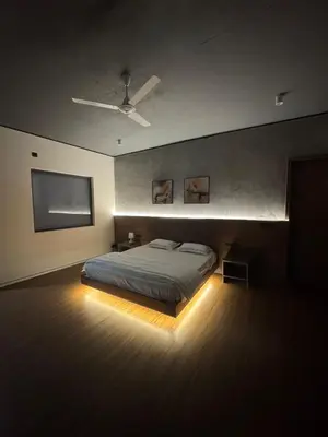 a bedroom with a bed and a flat screen tv at A private room in a luxury villa- The Water's Edge in Kotagiri