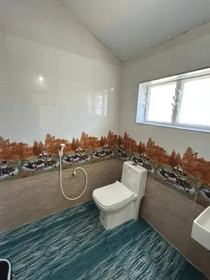 a bathroom with a toilet and a sink and a window at Majestry Cottage in Ooty