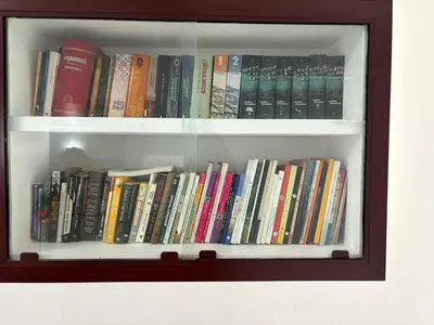 a book shelf filled with lots of books at Ravi's homestay in Cochin
