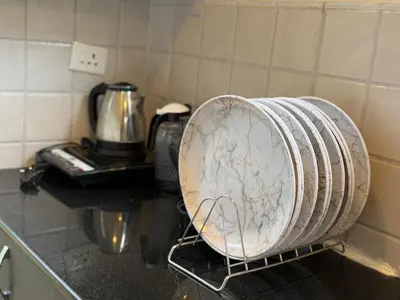 a toaster oven sitting on a counter in a kitchen at The Leafy Nook Container Stay- 360 degree Tea Plantation near Ooty in Coonoor