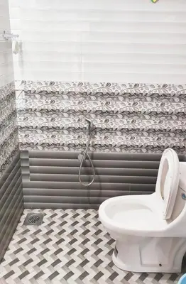 a bathroom with a toilet and a shower at Sintra Villa in Meppādi