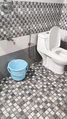 a bathroom with a toilet and a bucket at Sintra Villa in Meppādi