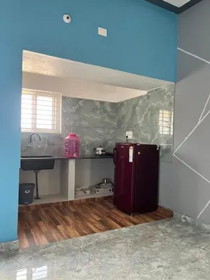 a kitchen with a purple refrigerator and a sink at Chamundi Temple-Hill View in Mysore