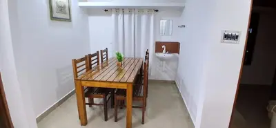 a bathroom with a wooden table and a sink at Vibgyor home stay in Pallipuram