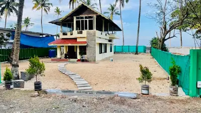a house in the middle of a beach at Vibgyor home stay in Pallipuram