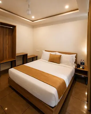 a bedroom with a large bed in a room at Nexstay Bayyat Inn in Kozhikode