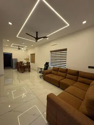 a living room with couches and a dining room at Serene riverside retreat in Kozhikode