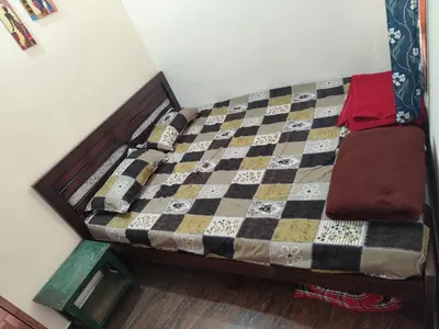 a bed in a room with a checkerboard at My Sooru - Spacious 2BHK Homely Retreat in Mysore
