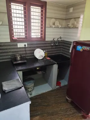 a kitchen with a sink and a counter top at My Sooru - Spacious 2BHK Homely Retreat in Mysore
