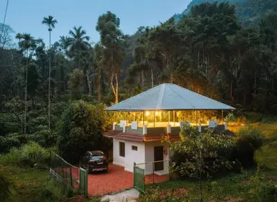 a house with a car parked in front of it at Forest edge Villa - 3 bedrooms in Ambalavayal