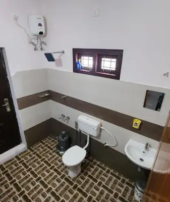 a bathroom with a toilet and a sink at Forest edge Villa - 3 bedrooms in Ambalavayal
