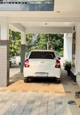 a white car parked inside of a garage at Sawan Home stay - 2 BHK fully furnished in Kozhikode