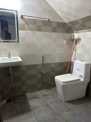 a bathroom with a toilet and a sink at Sawan Home stay - 2 BHK fully furnished in Kozhikode