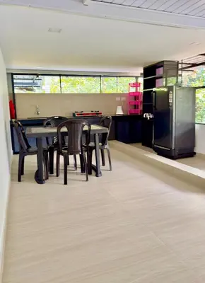 a dining room with a table and chairs and a refrigerator at Sawan Home stay - 2 BHK fully furnished in Kozhikode