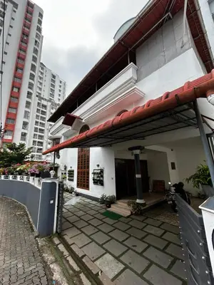 a white building with a red roof at Metro Bliz in Alwaye