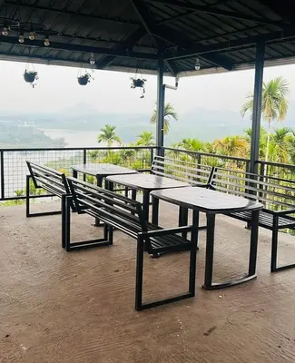 a group of picnic tables sitting on top of a building at Valensa lake view in Kalpetta