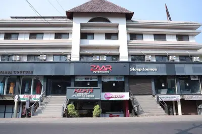 a large building with a store in front of it at Amani Residency Kannur in Kannur
