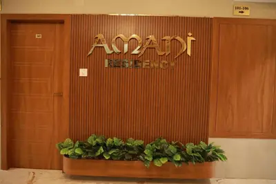 an entrance to a restaurant with plants in front of it at Amani Residency Kannur in Kannur