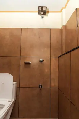 a bathroom with a shower with a toilet and a sink at Wayanad home stay in Vythiri