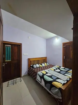 a bedroom with a bed in a room at Falcon by wayanora in Padinjarathara