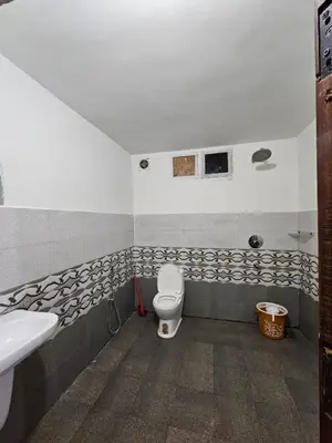 a bathroom with a toilet and a sink at Falcon by wayanora in Padinjarathara
