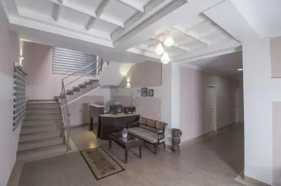 a living room with a staircase and a table at Mounts shelts in Munnar
