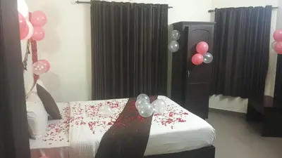 a bedroom with balloons and a bed with a bed sidx sidx sidx at Mounts shelts in Munnar