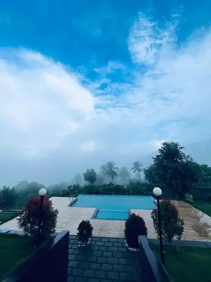 a view of a swimming pool in a yard at WHITE FLOWER mountain resort in Perintalmanna