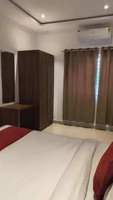 a bedroom with a large bed and a closet at Hemara suites