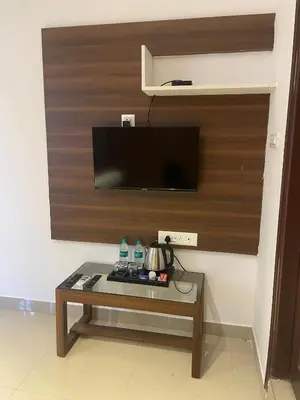 a living room with a coffee table with a tv at Hemara suites
