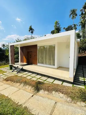 a modern house with a large backyard at West wind Resort in Meppādi