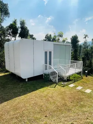 a large white house sitting on top of a yard at West wind Resort in Meppādi
