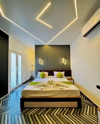 a bedroom with a large bed in a room at West wind Resort in Meppādi