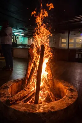 a fire in a pot with flames in it at Secret Escape Heritage Bungalow in Ooty