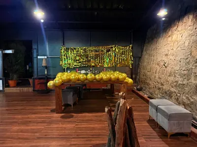 a stage with a table in the middle of a room at Secret Escape Heritage Bungalow in Ooty