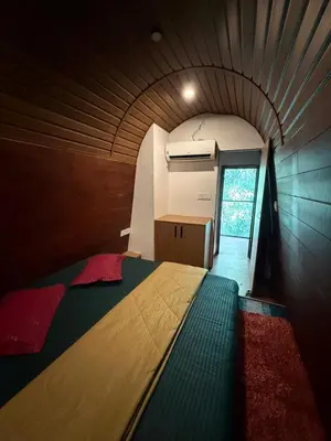 a bedroom with a bed in a small room at Lostcabins in Vallikavungal