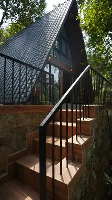 a set of stairs leading to a house at Lostcabins in Vallikavungal
