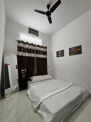 a bedroom with a bed and a ceiling fan at Arranyaa retreatt- Girrafe's gallery in Mysore