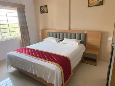 a bedroom with a large bed in a room at Nova Alhind Airport Hotel in Nedumbassery