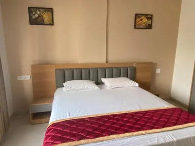 a bedroom with a large bed with a red blanket at Nova Alhind Airport Hotel in Nedumbassery