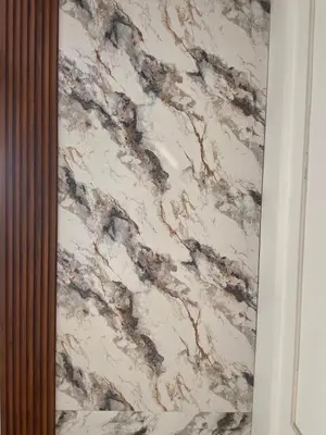 a white and brown marble wall in a bathroom at Nova Alhind Airport Hotel in Nedumbassery