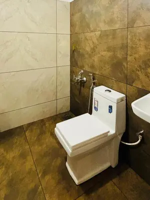 a bathroom with a toilet and a sink at Neelees Retreat in Kaniyāmbetta