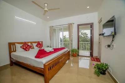 a bedroom with a bed with a red blanket at Silver Heaven, Kotagiri in Kotagiri