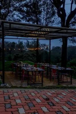 a group of tables and chairs under a pavilion at Silver Heaven, Kotagiri in Kotagiri